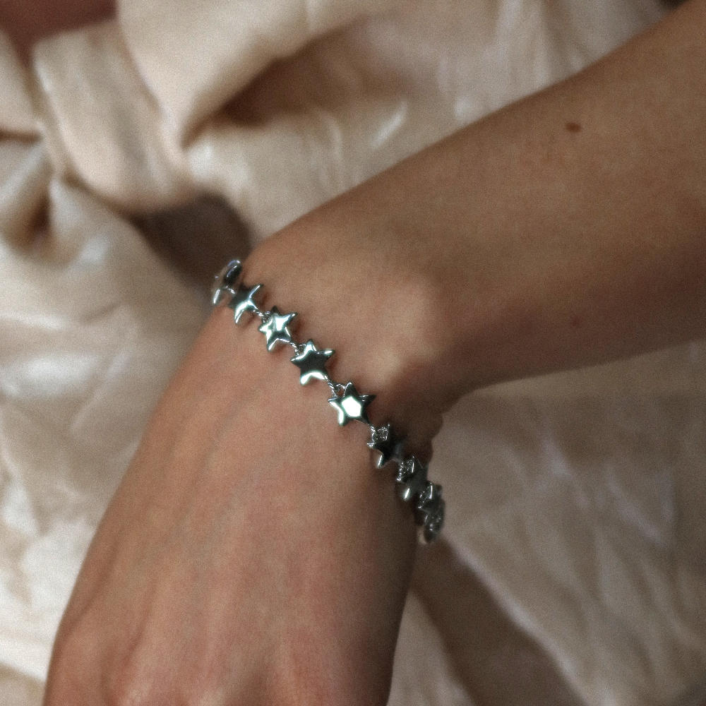 Rush silver star pattern shiny heavy weight trendy popular men women bracelet Unisex silver star bracelet from Rush with interlinked star charms and adjustable clasp, offering a playful yet minimalist statement look