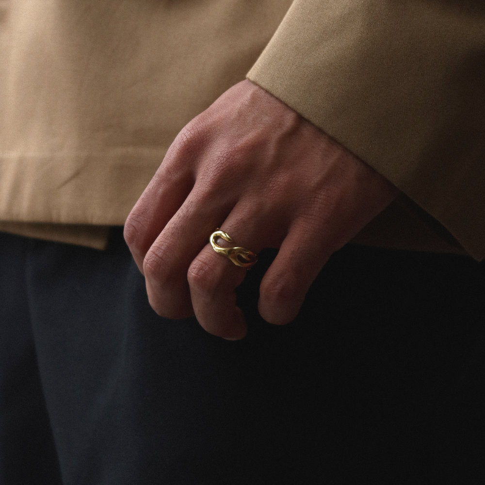 Unisex gold open ring from Rush with an abstract fluid shape, polished finish, and bold sculptural design for statement styling men women popular trendy sleek irregular shaped ring 