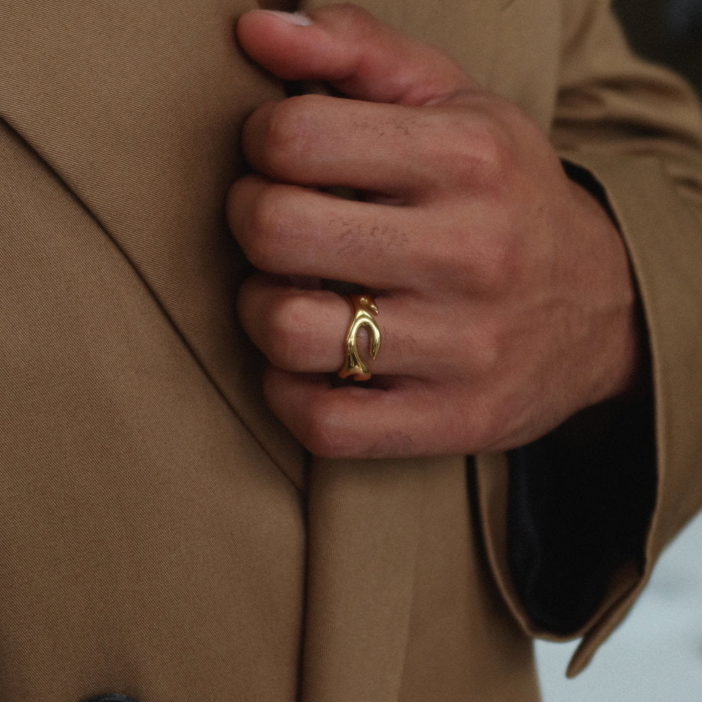 Unisex gold open ring from Rush with an abstract fluid shape, polished finish, and bold sculptural design for statement styling men women popular trendy sleek irregular shaped ring 