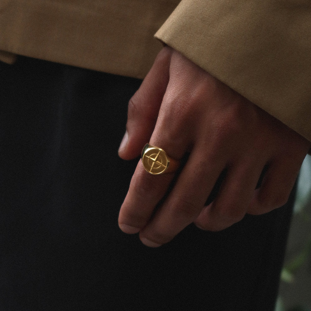 Unisex gold compass signet ring from Rush with an engraved compass design, polished finish, and bold modern style for everyday or statement wear. men women trendy popular sleek ring 