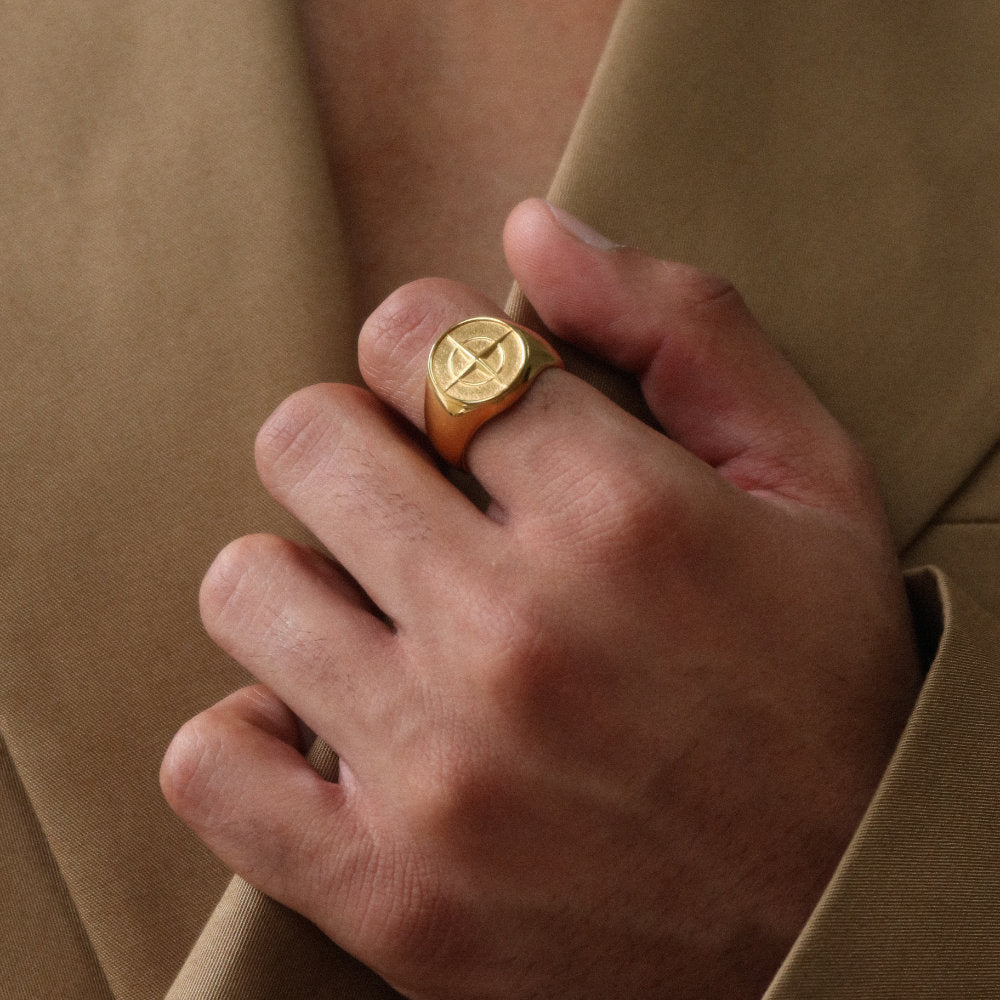 Unisex gold compass signet ring from Rush with an engraved compass design, polished finish, and bold modern style for everyday or statement wear. men women trendy popular sleek ring 