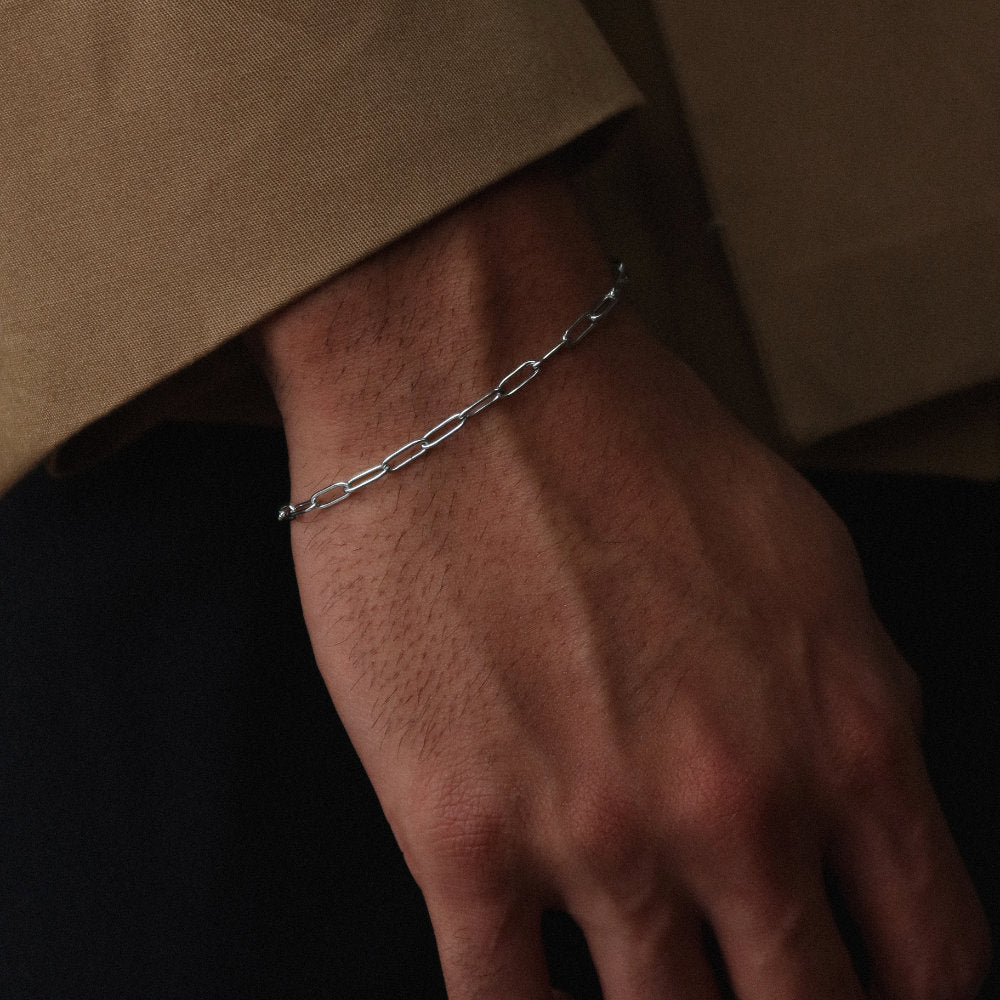 Rush paper clip chain silver men women popular trendy sleek bracelet Unisex silver elongated link bracelet from Rush featuring a sleek paperclip chain design, perfect for layering or solo statement styling.