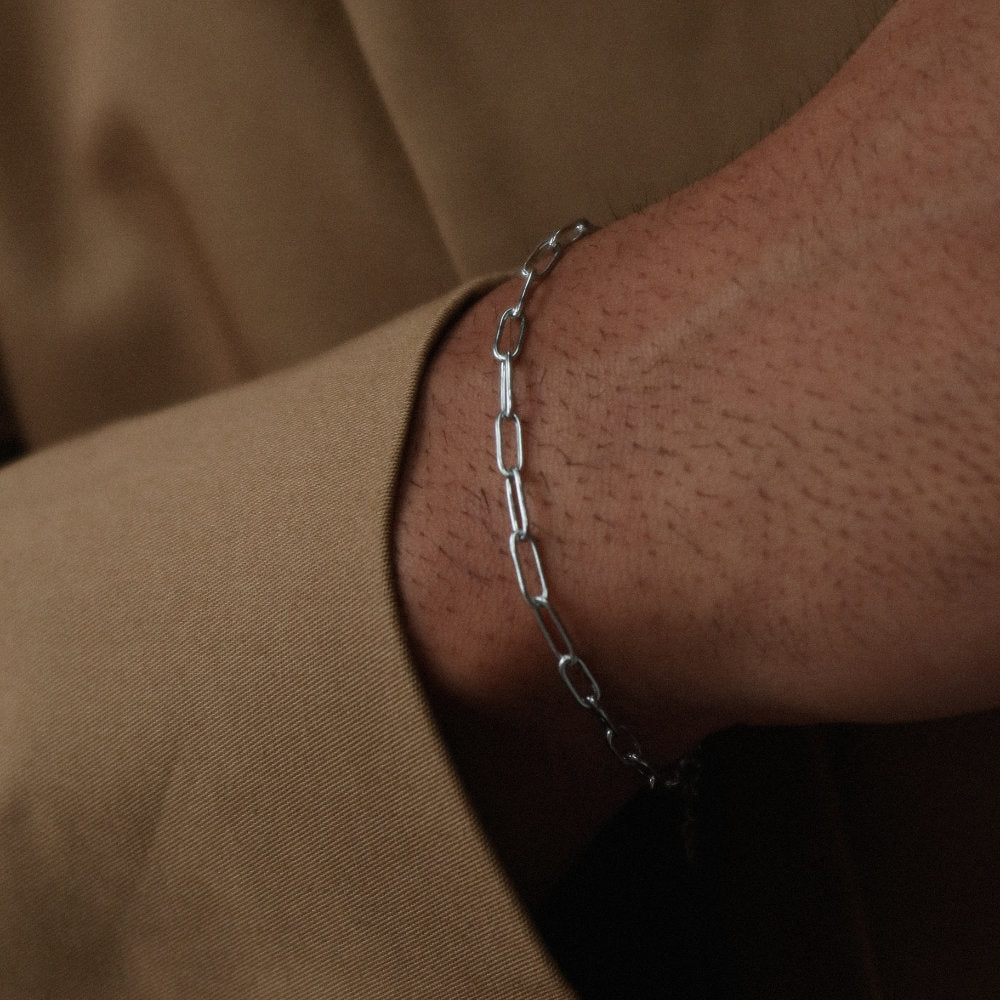 Rush paper clip chain silver men women popular trendy sleek bracelet Unisex silver elongated link bracelet from Rush featuring a sleek paperclip chain design, perfect for layering or solo statement styling.
