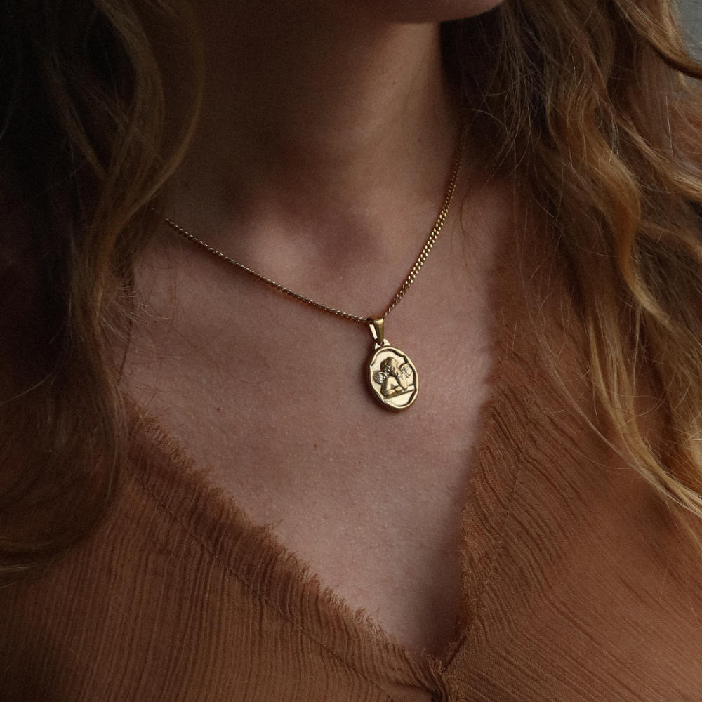 men women gold necklace with cherub medallion pendant from Rush, designed with engraved detailing and a refined polished finish for versatile wear. trendy popular angel necklace 