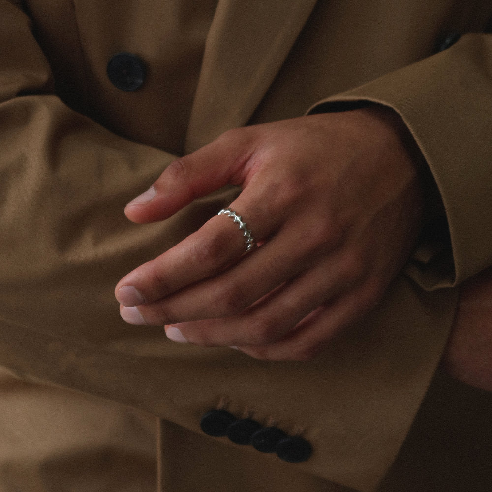 Rush silver ring with geometric design men women trendy popular ring 
Unisex silver scalloped band ring from Rush with a repeating geometric edge design and polished minimalist finish for everyday wear.